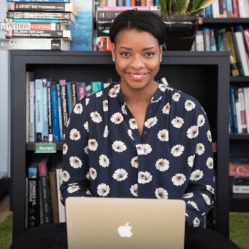 a woman on a laptop in a library