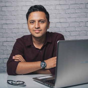 a man sitting at a table with a laptop